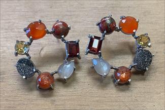 Gollberg.warm colors of prong set stones