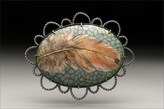 Hur.enamel brooch of brownand green blue feather