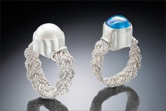 Hurant.braided silver rings with white and blue stones
