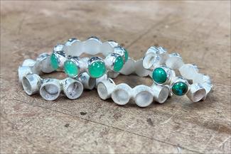 Hurant.silver bezel bands with green stones