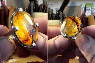 Keast.prong ring with yellowish stone