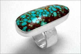 Pabon.silver cab ring with blue brown stone
