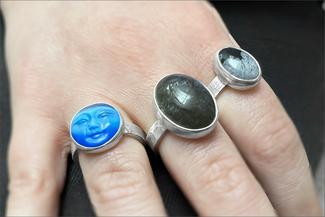 Lawton.blue dark and multi color rings on fingers