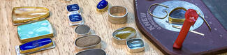 Colorful stones are lined up on a wooden table