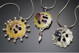 Three pendants by Kathryn Osgood made with vitreous enamels and die forming techniques.