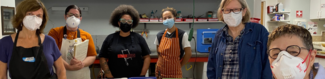 A class with instructor Tanya Crane stands in the Metalwerx classroom