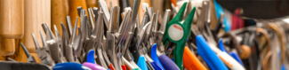 A close-up view of many plier heads, all lined up and pointing up